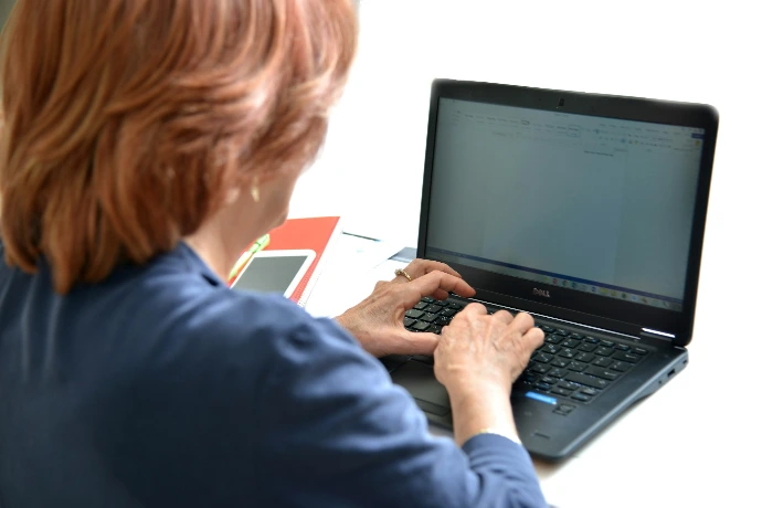 man in blue long sleeve shirt using black laptop computer